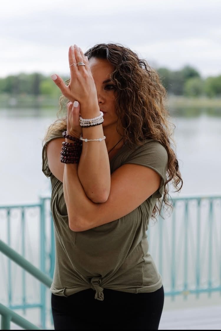 Close-up of hands in prayer position during an outdoor yoga session